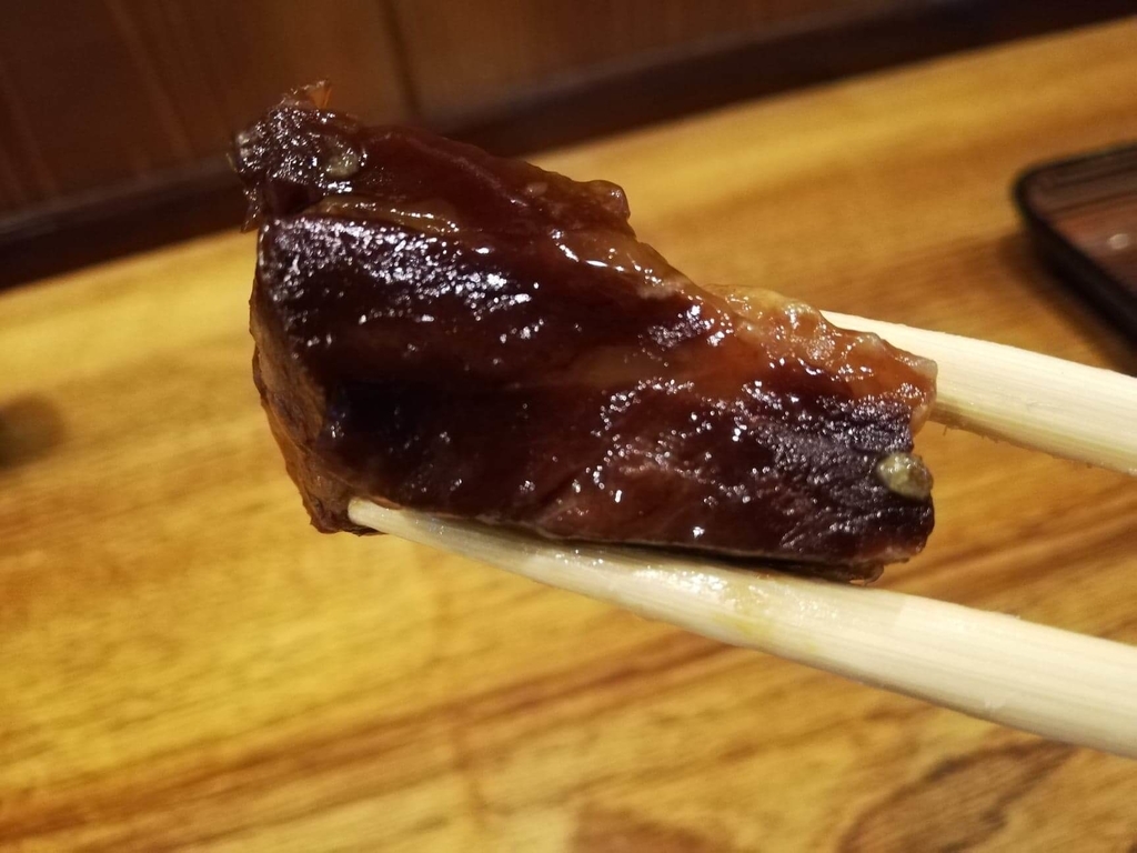 長崎『吉宗本店』の吉宗定食の、豚の角煮の筋の部分を箸で掴んだ写真