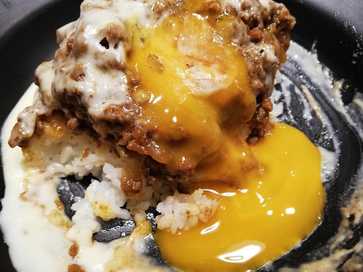 池袋『CHEESE CHEESE ＆ Meat. COMTE』のキーマカレーに卵黄をかけた写真