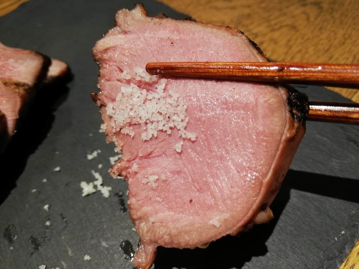 香川県高松市『瀬戸内豚料理紅い豚』の豚タンに塩をつけた写真